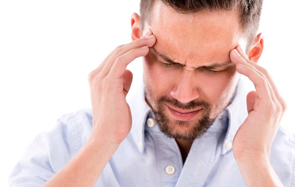 Frustrated business man with a headache - isolated over white